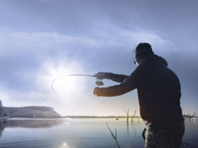 man fishing on a lake